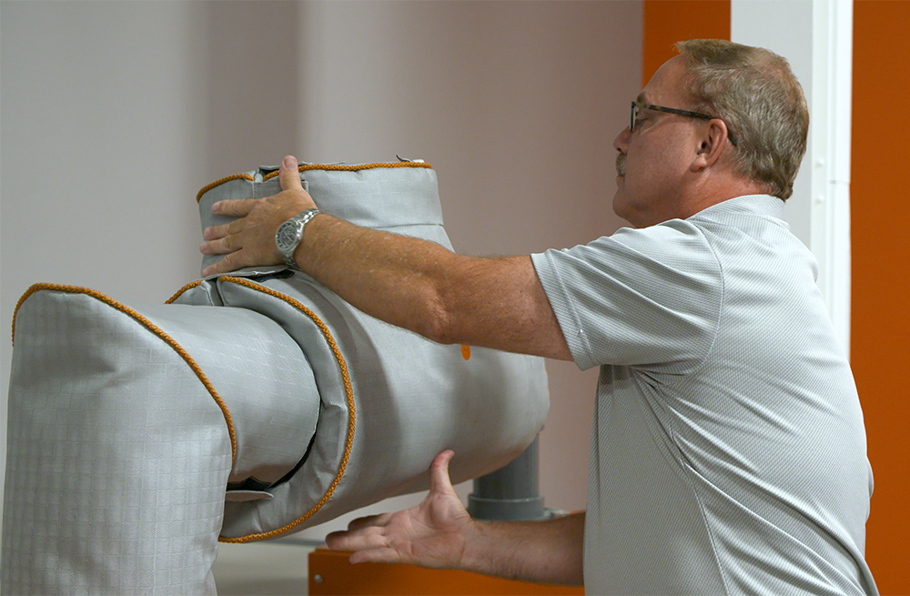 McAllister Mills engineer fitting a custom insulation jacket