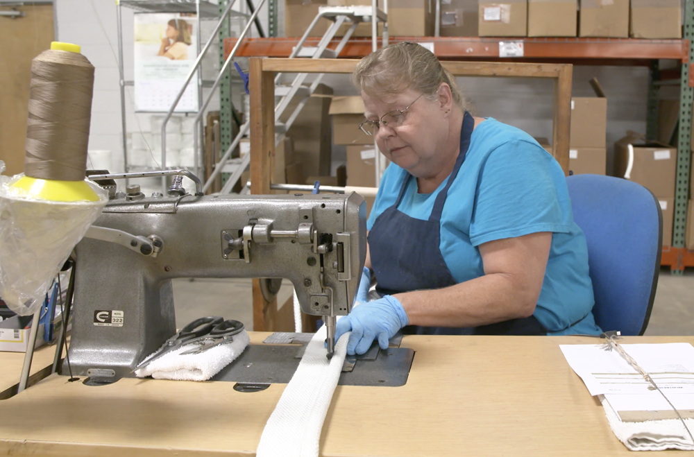 McAllister Mills employee sewing a tadpole tape